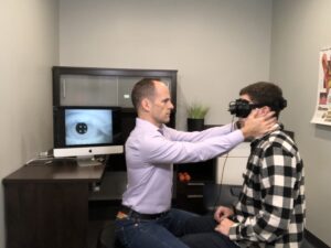 Helping a patient with vertigo using VNG goggles