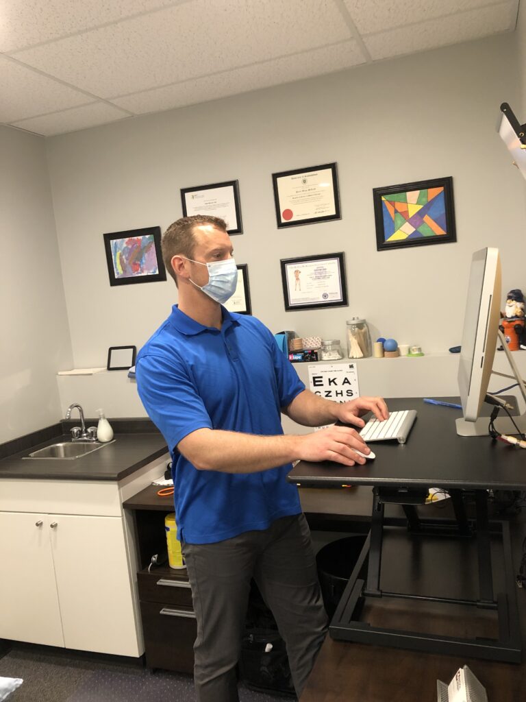 physical therapy specialist wearing face mask for safety providing services during COVID-19 pandemic