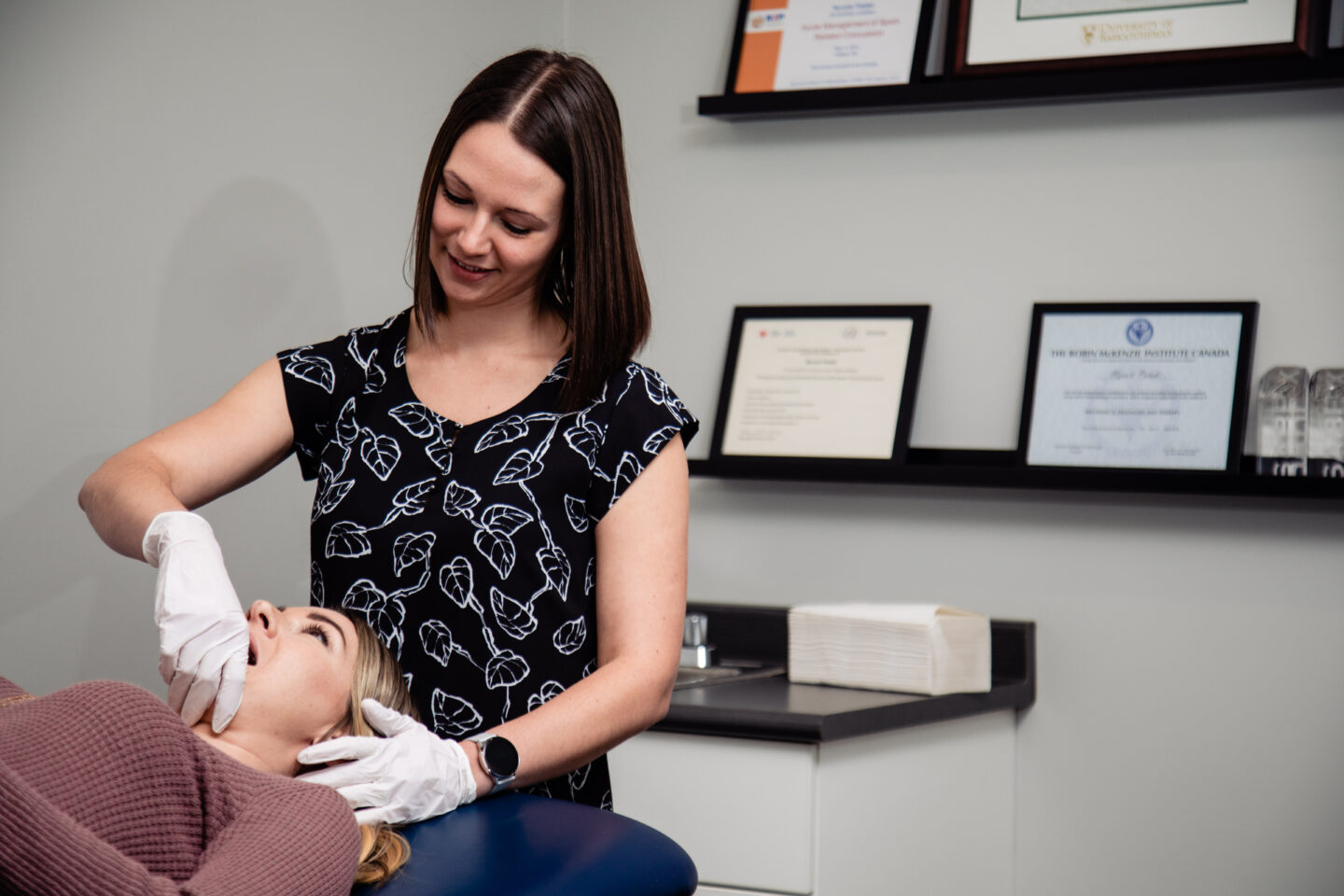 Nycole Pataki, a physiotherapist, performing manual therapy internally on patient needing temporomandibular (TMD) treatment