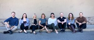 North 49 Physical Therapy team members sitting on a curb